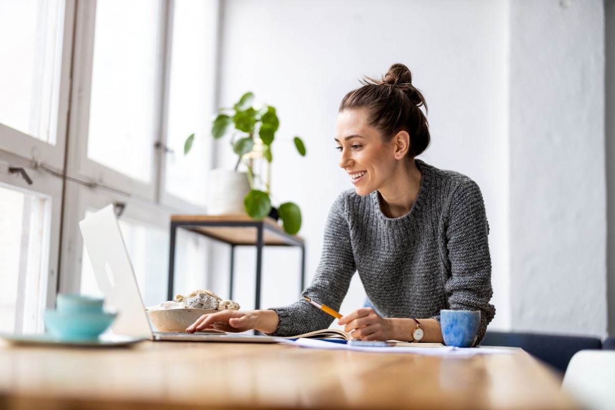 Creative young woman working on laptop in her studio