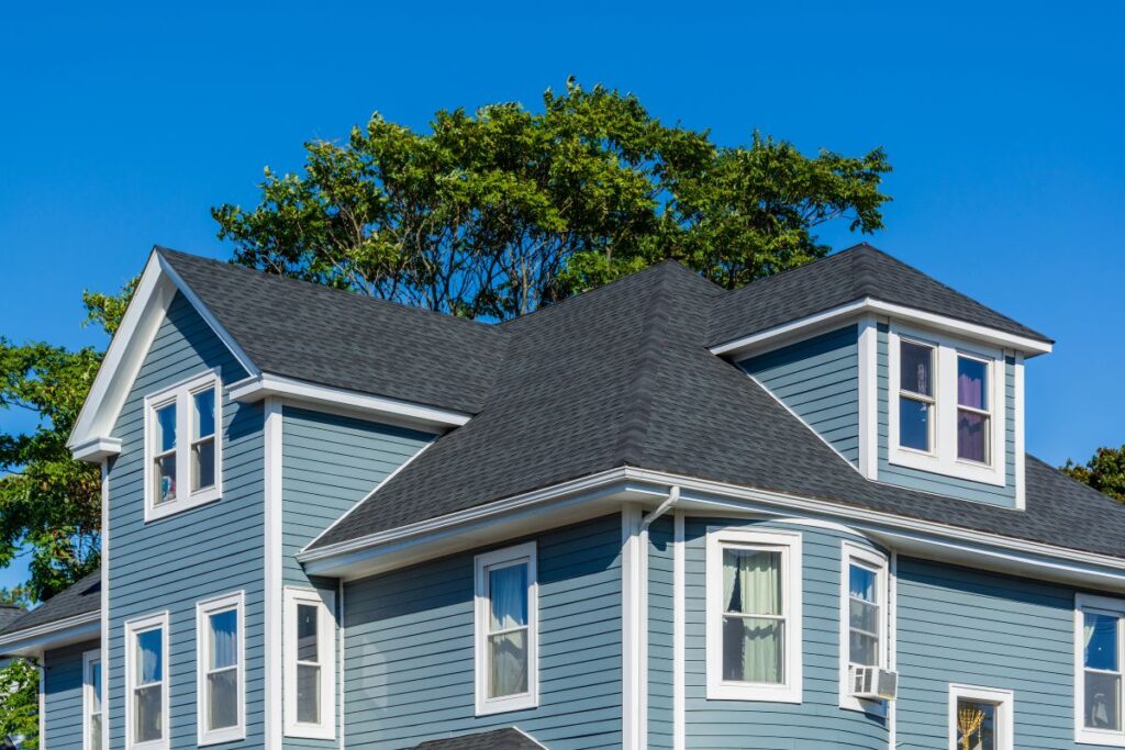 Big house with blue siding and white trims