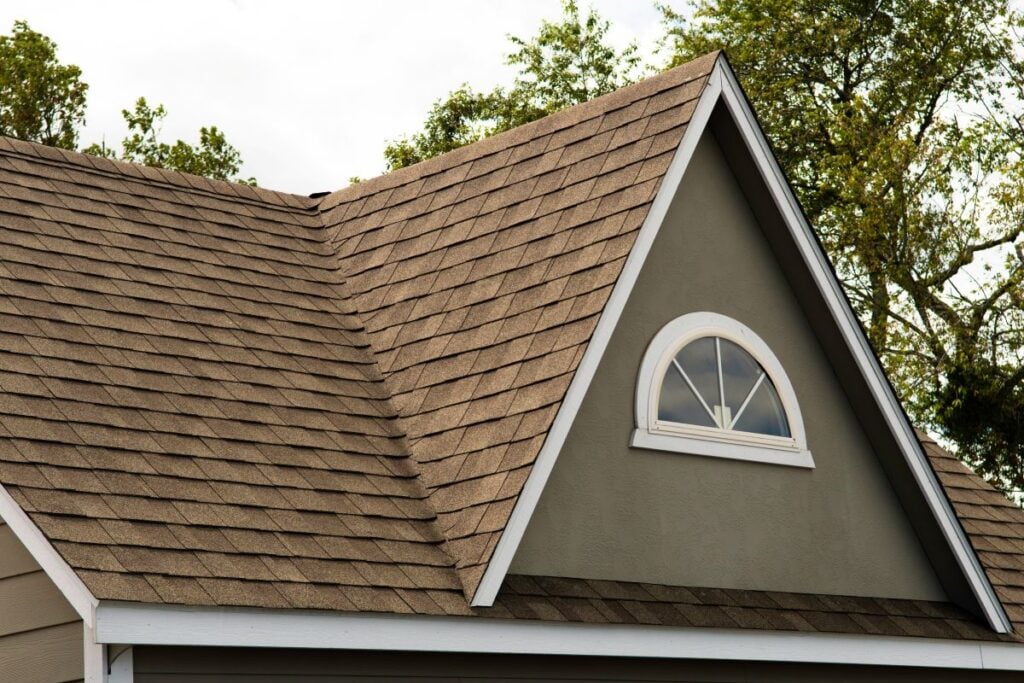 green house with brown shingle roof